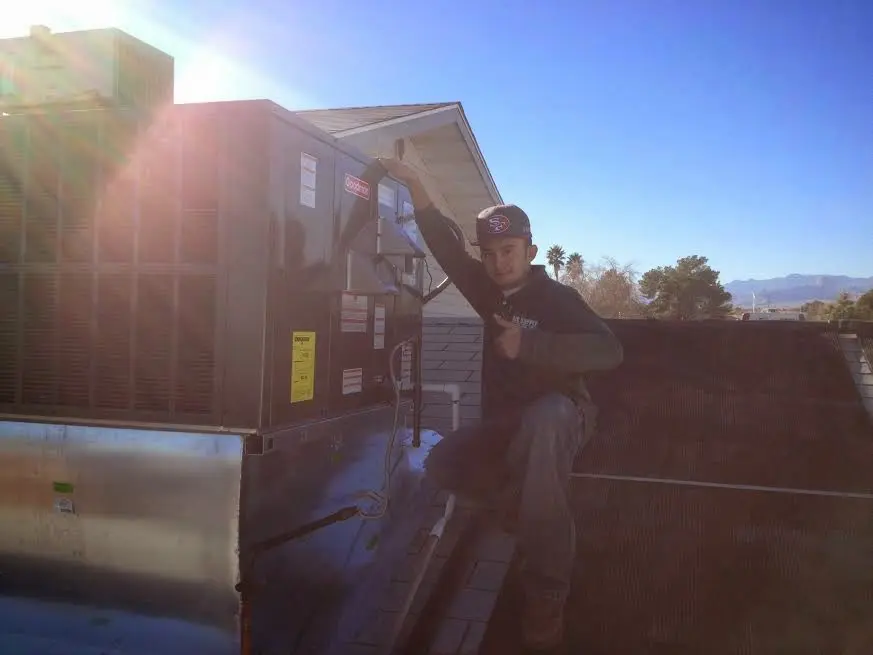 HVAC technician performing Boiler Repair on a rooftop unit in Crouch Mesa